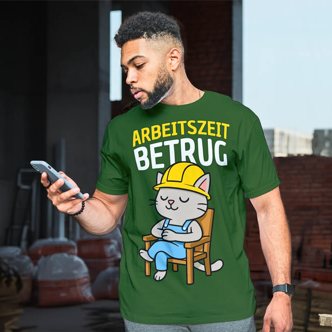 Mann trägt grünes T-Shirt mit Bauarbeiter-Katzenmotiv und dem Spruch Arbeitszeitbetrug auf Baustelle